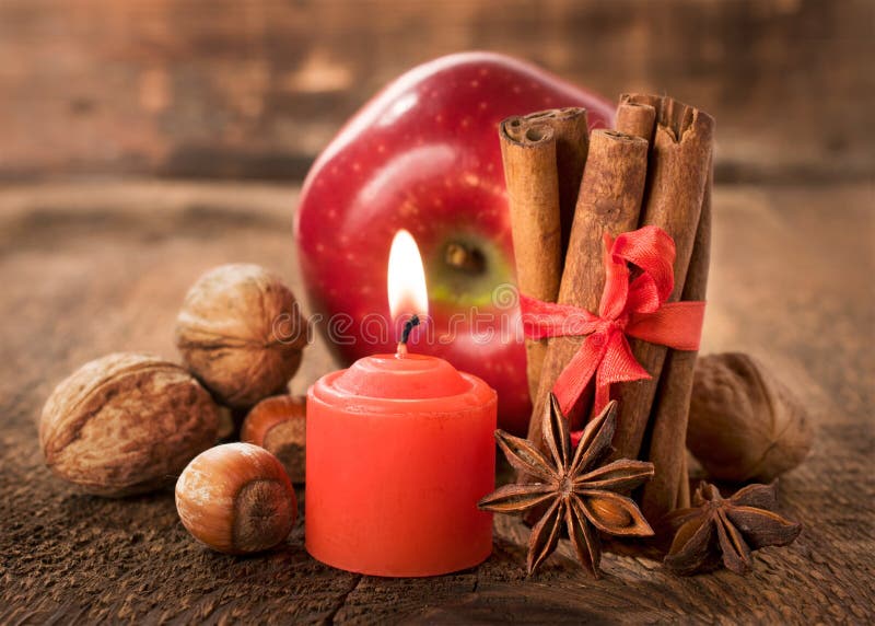 Apple with nuts, star anise , cinnamon and a candle