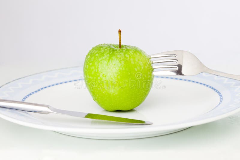 Apple on plate stock image. Image of cutlery, fork, green - 20503065
