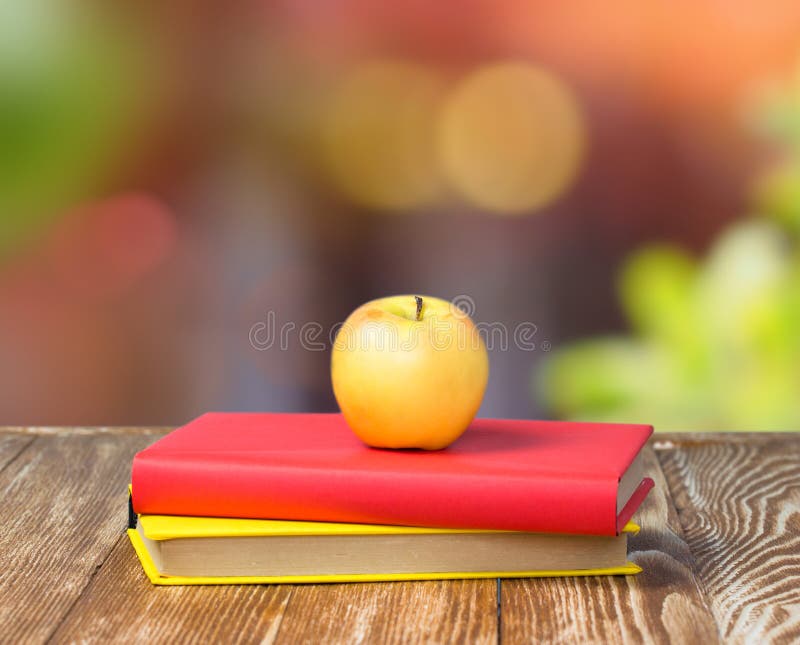 Apple on stack books empty space nature background.