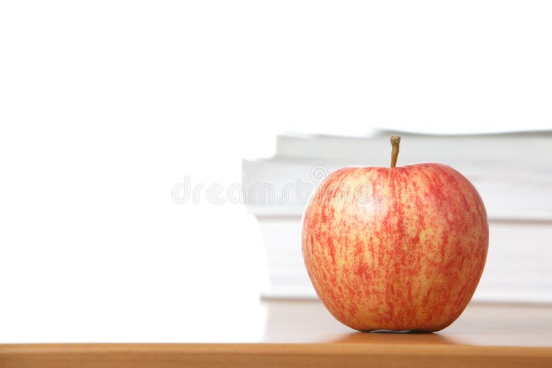 An apple on a teachers desk