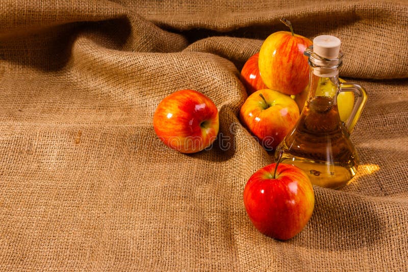 Apple vinegar on a wooden rustic background