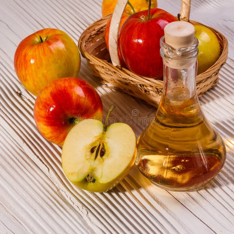 Apple vinegar on a wooden rustic background