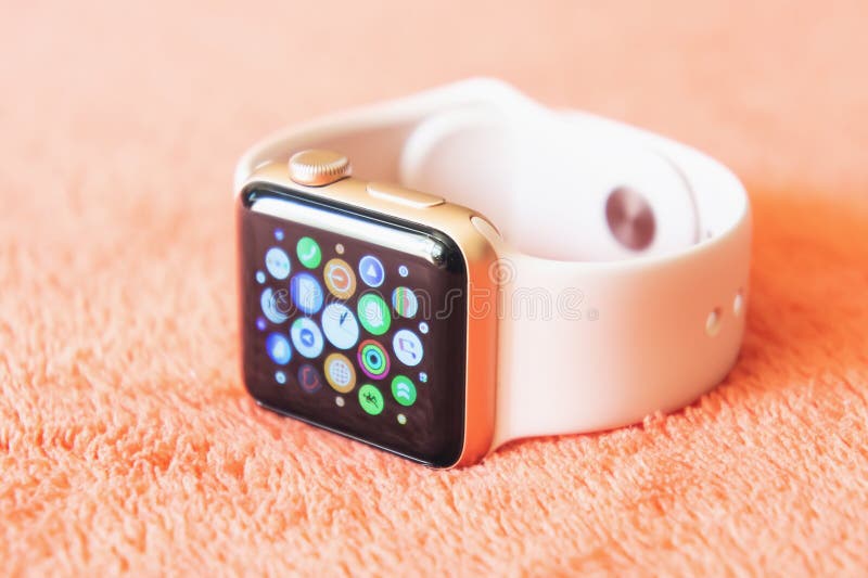 Apple Watch Gold on a soft fluffy peach-colored background royalty free stock photo