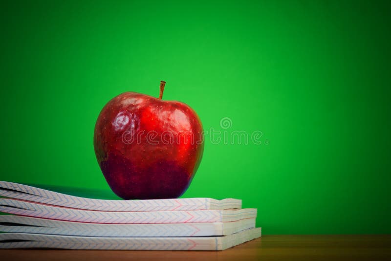 Apple on writing-books stock photo. Image of tool, college - 32921264