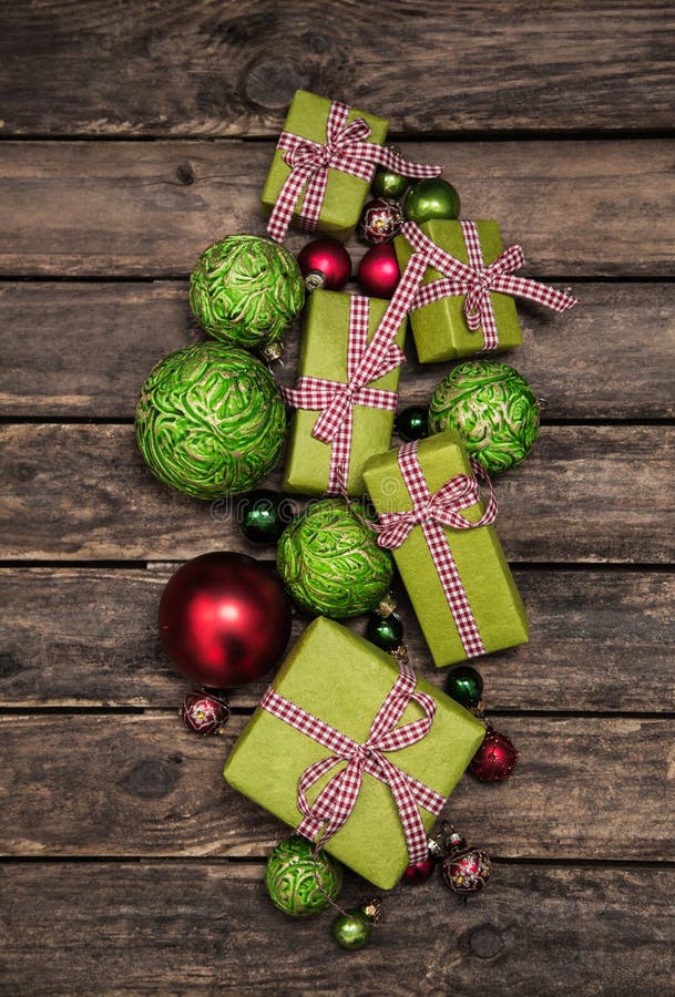 Apple green christmas gift boxes with a red white check ribbon on old wooden bard for decoration. Apple green christmas gift boxes with a red white check ribbon on old wooden bard for decoration.