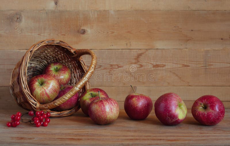 Apples in a basket on a wooden background