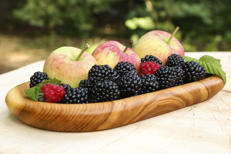 Apples and Berries on a Wooden Plate, Closeup Stock Photo Image of