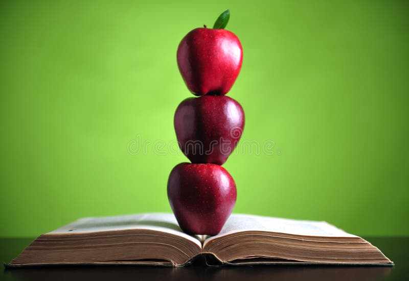 Apples on book