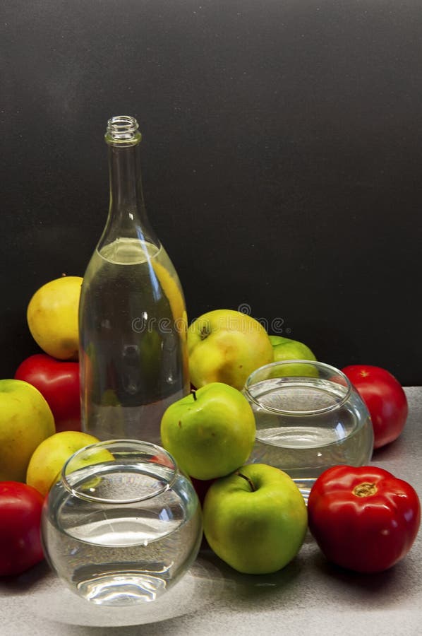 Photo apples green and red tomatoes with bottle and glasses stock photos