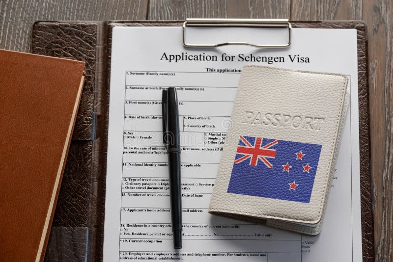 Application form, pen and a New Zealand passport. Getting a Schengen visa. Application form, pen and a New Zealand passport. Travelling to Europe stock image