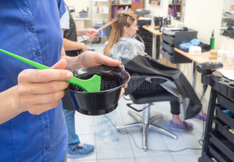 Application of the reducing composition to the hair. Female holding messy unbrushed dry hair stock images, royalty-free photos and pictures