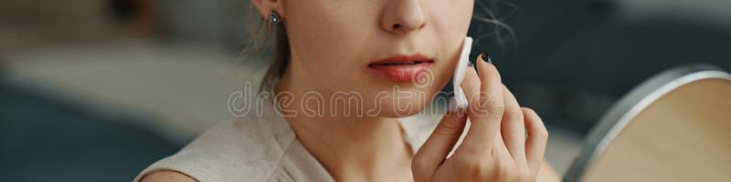 Applying Makeup with Mirror Reflection and Concentration stock images