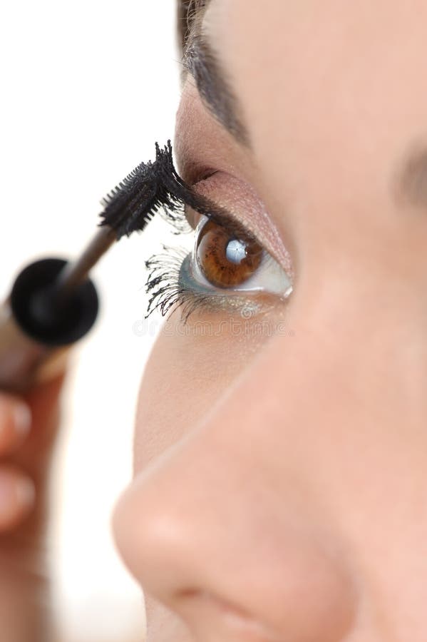 Applying mascara using lash brush stock photo Applying mascara using lash brush stock photo