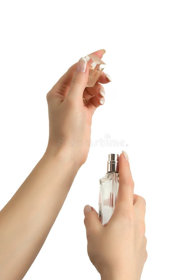 Woman applying perfume on her right wrist, from luxury bottle. Isolated on white.