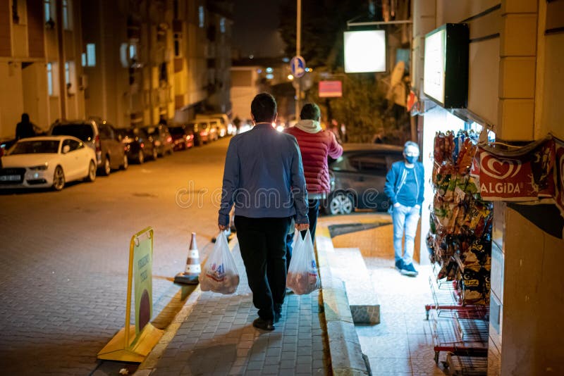 People staying in Queues in front of shops to buy food befor the 2-Day curfew. It is 23.00 and in 1 Hour the curfew begins. People staying in Queues in front of shops to buy food befor the 2-Day curfew. It is 23.00 and in 1 Hour the curfew begins.