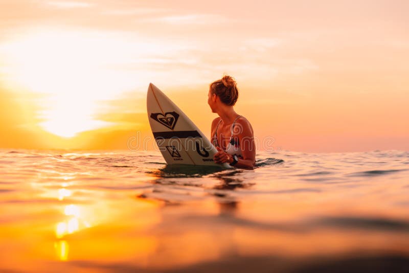 25 april 2019. Bali, Indonesia. Attractive surfer woman on a surfboard in ocean stock photos 25 april 2019. Bali, Indonesia. Attractive surfer woman on a surfboard in ocean stock photos