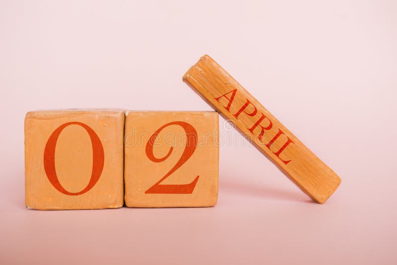 april 2nd. Day 2 of month, handmade wood calendar  on modern color background. spring month, day of the year concept