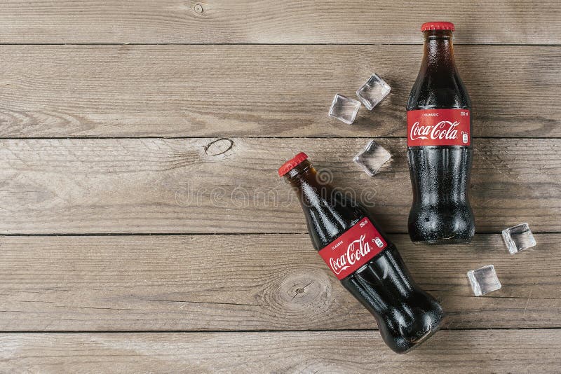 Coca-Cola Bottle with Ice Cubes on Wooden Background. Editorial Stock Image  - Image of coke, brand: 145780209
