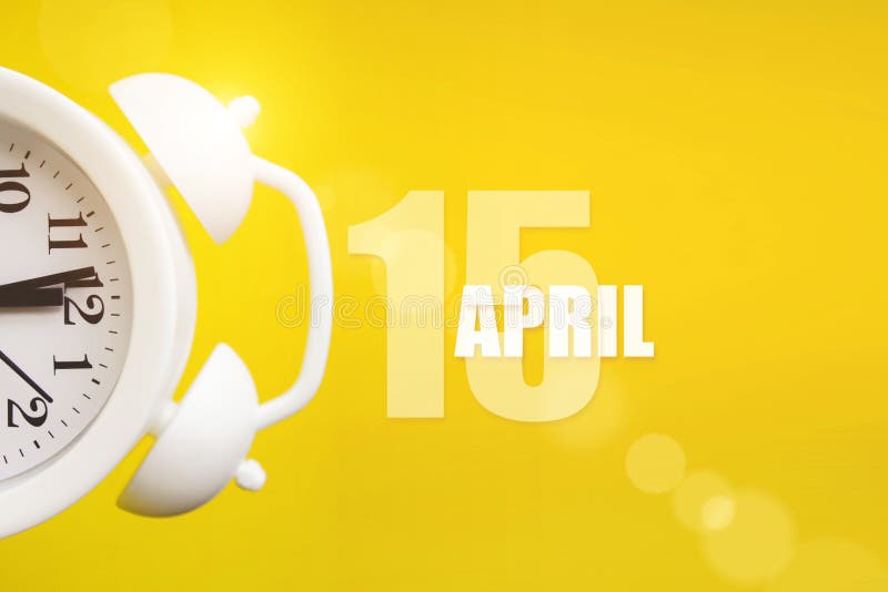 April 15th. Day 15 of month, Calendar date. White alarm clock on yellow background with calendar day. Spring month, day of the royalty free stock photos