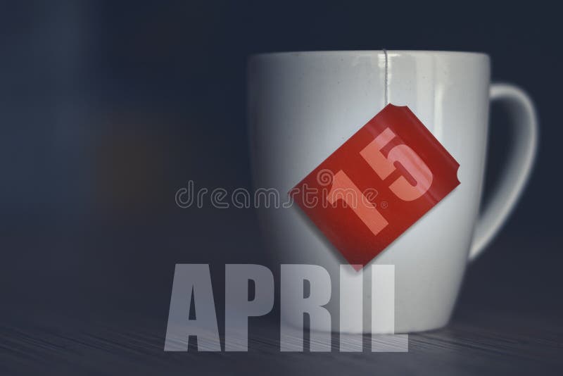 April 15th. Day 15 of month,Tea Cup with date on label from tea bag. spring month, day of the year concept royalty free stock photos