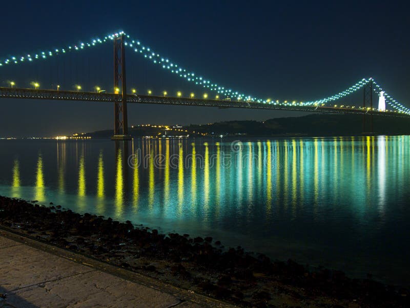 Night view of the April 25 (25 de Abril) Bridge in Lisbon, Portugal as seen from the Belem district. Completed in 1966 , this suspension bridge across the Tagus River is the longest central span in Europe. Originally named after dictator Salazar, the name was changed after the revolution of April 25, 1974. Night view of the April 25 (25 de Abril) Bridge in Lisbon, Portugal as seen from the Belem district. Completed in 1966 , this suspension bridge across the Tagus River is the longest central span in Europe. Originally named after dictator Salazar, the name was changed after the revolution of April 25, 1974.