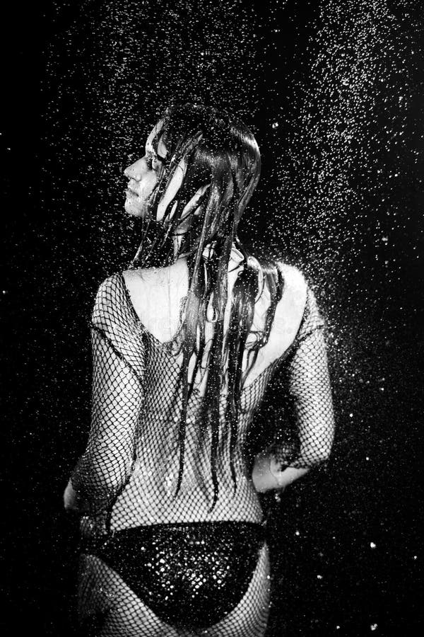 Aqua photo session woman under rain drops black and white studio