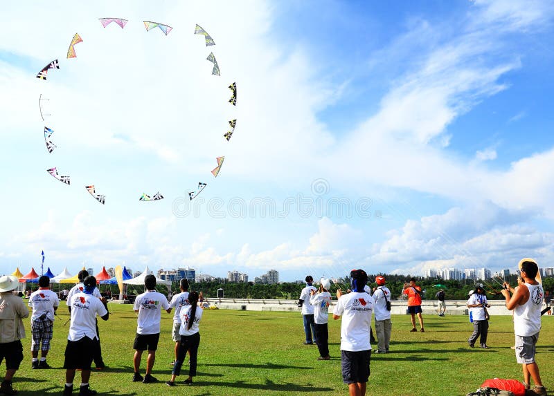 People are flying group kites at marina barrage in singapore. People are flying group kites at marina barrage in singapore