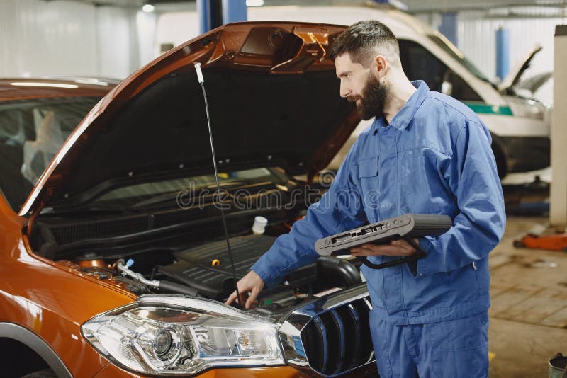 Ar Mechanic with a Tablet Near Car in Work Clothes Stock Image Image