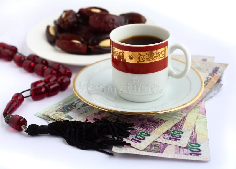 Arab business concept. Coffee, Arabian high-value bank notes, a plate of dates and worry beads - the essentials for doing business in the arab world