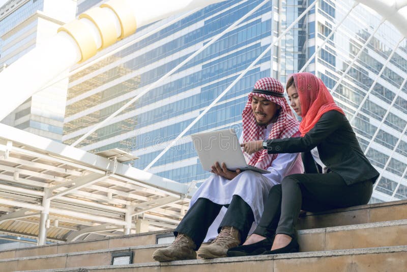 Arab Businessman and Businesswoman using computer