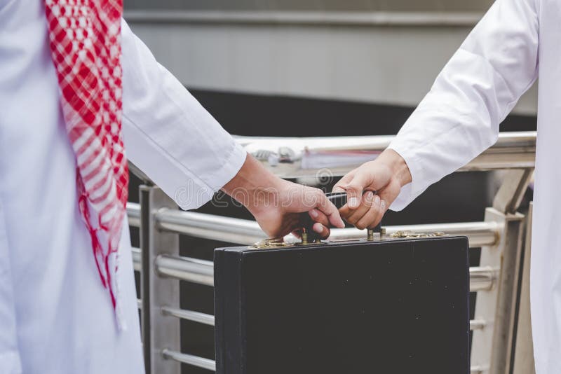 Arab Businessman shaking hands together. Teamwork business partner wear Muslim dress Shake Hands with Partnership Concept. Success royalty free stock images Arab Businessman shaking hands together. Teamwork business partner wear Muslim dress Shake Hands with Partnership Concept. Success royalty free stock images