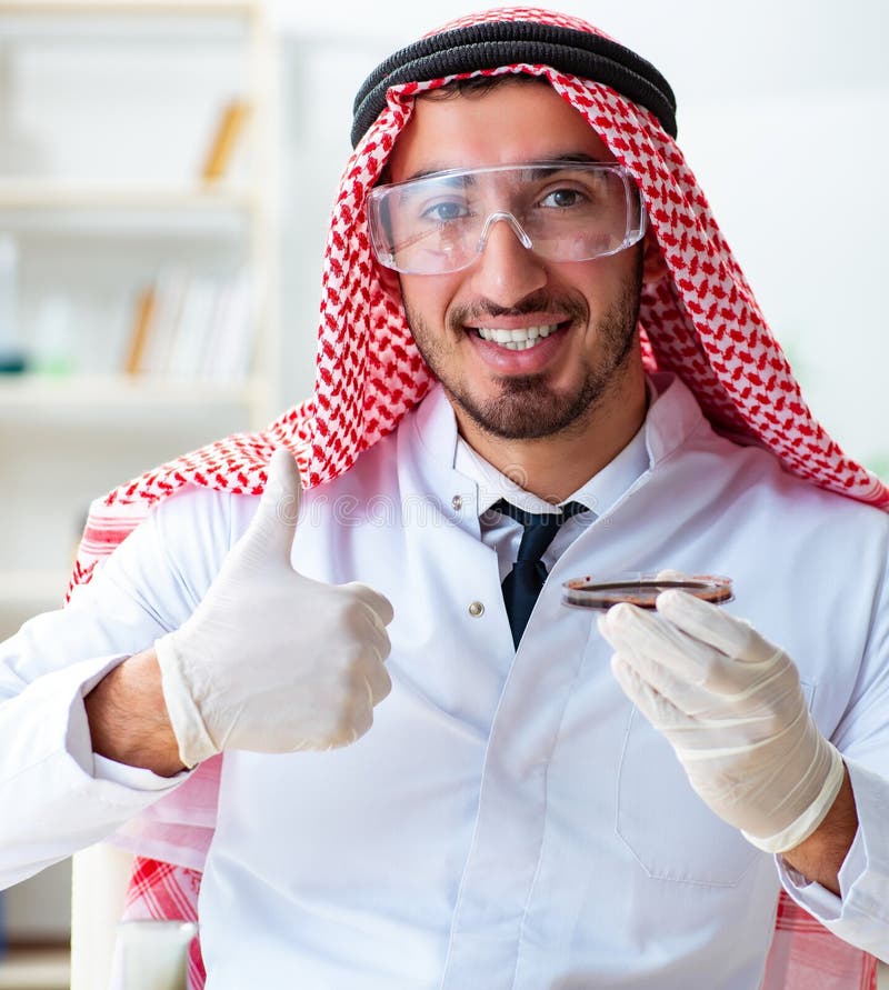 Arab chemist working in the lab office stock images