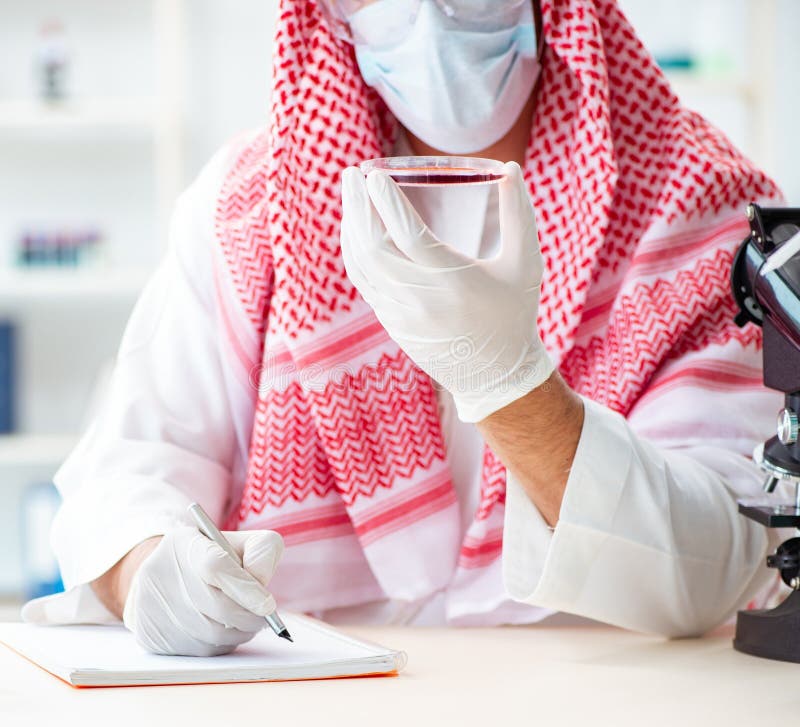Arab doctor chemist studying new virus in lab royalty free stock images