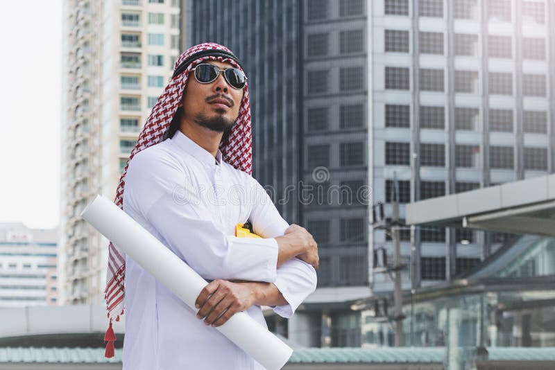 Arab Engineer construction worker holding blueprint stock image