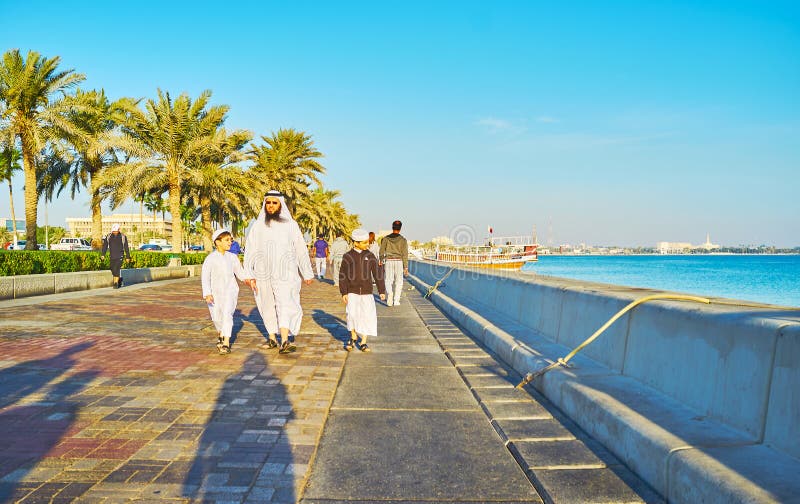 Arab family walking in Doha, Qatar stock photo