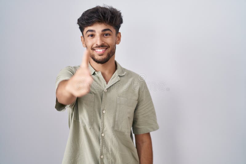 Arab Man with Beard Standing Over White Background Smiling Friendly