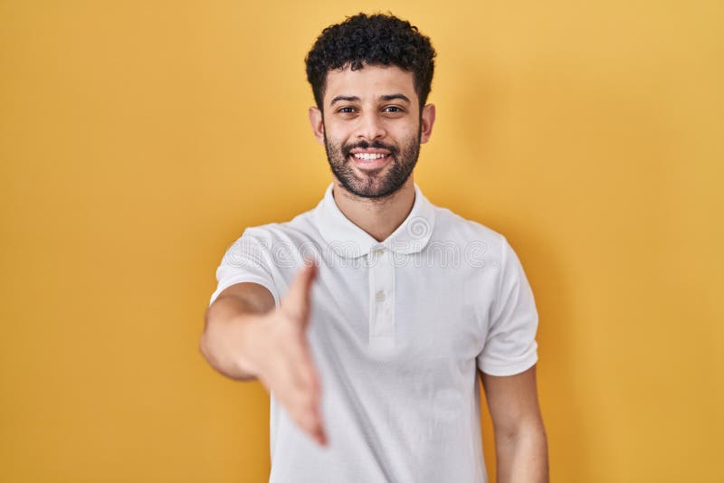 Arab Man Standing Over Yellow Background Smiling Friendly Offering