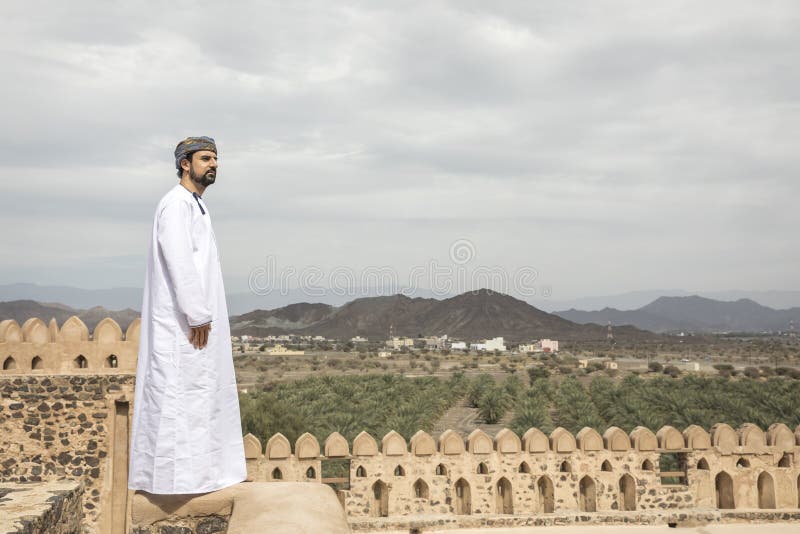 Arab man in traditional omani outfit in an old castle