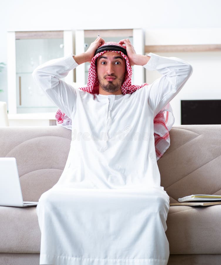 Arab man working at home on his work stock images