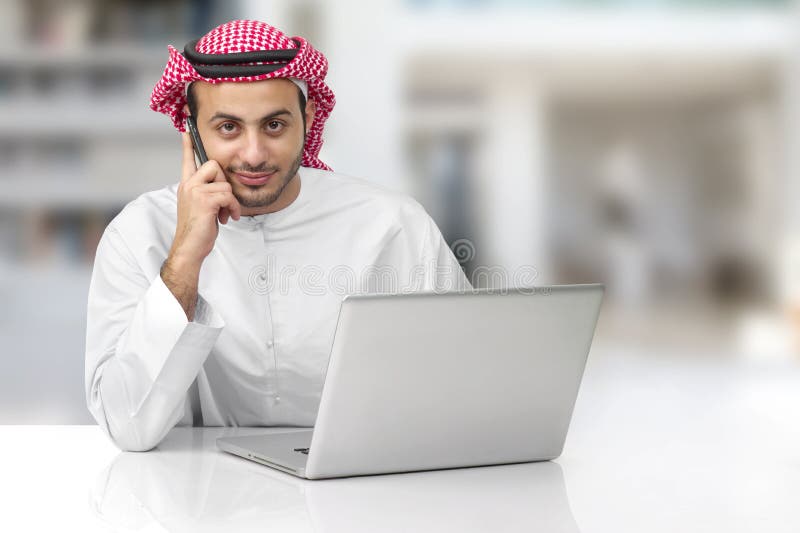 Arabian business man talking on phone in his office