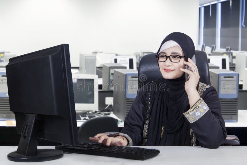 Arabian female worker works with computer