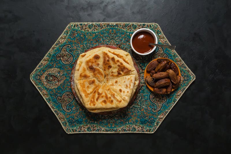 Arabic Cheese Bread with Dates on a Black Table. Stock Photo Image of