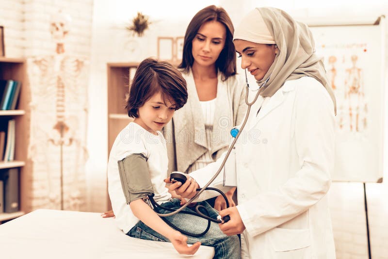 Arabic Female Doctor Checking Blood Pressure Boy