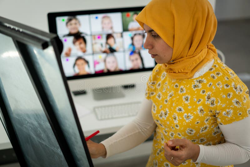 Arabic Female Teacher Working With Children Online School Stock Image