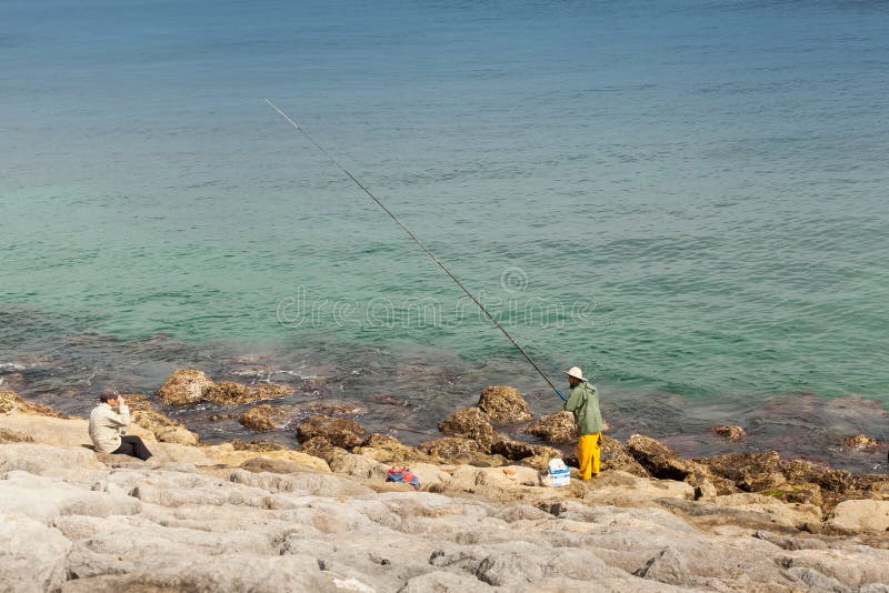 Arabic Fisherman, Repairing Home-made Fishing Net and Wooden Yacht, Wearing Face Mask and Sits