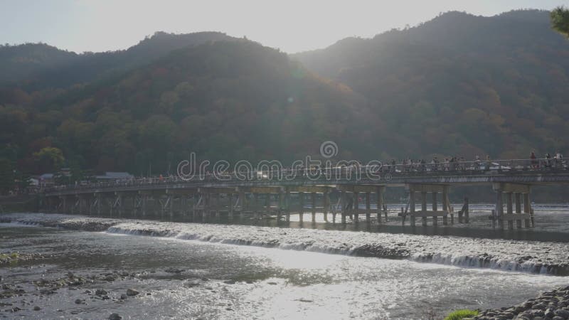 Arashiyama  Kyoto Japan. Slow motion pan over Togetsukyo Bridge at Sunset