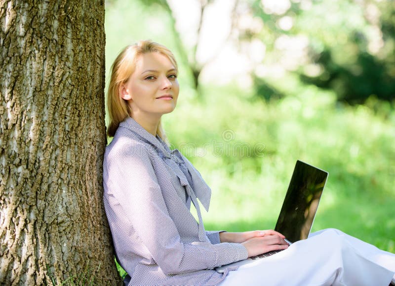 Work outdoors benefits. Woman with laptop work outdoors lean tree. Minute for relax. Girl work with laptop in park sit on grass. Education technology and internet concept. Natural environment office. Work outdoors benefits. Woman with laptop work outdoors lean tree. Minute for relax. Girl work with laptop in park sit on grass. Education technology and internet concept. Natural environment office.