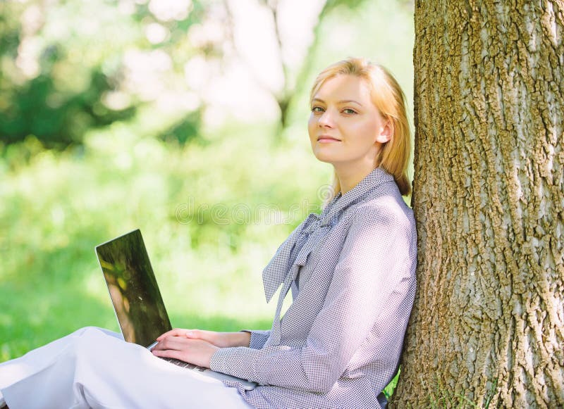 Work outdoors benefits. Woman with laptop work outdoors lean tree. Minute for relax. Girl work with laptop in park sit on grass. Education technology and internet concept. Natural environment office. Work outdoors benefits. Woman with laptop work outdoors lean tree. Minute for relax. Girl work with laptop in park sit on grass. Education technology and internet concept. Natural environment office.