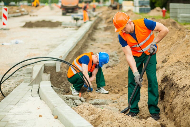 Image of two workers on a road construction. Image of two workers on a road construction