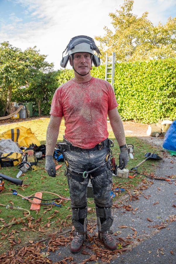 Arborist or Tree Surgeon wearing safety equipment covered in sawdust. Arborist or Tree Surgeon wearing safety equipment covered in sawdust